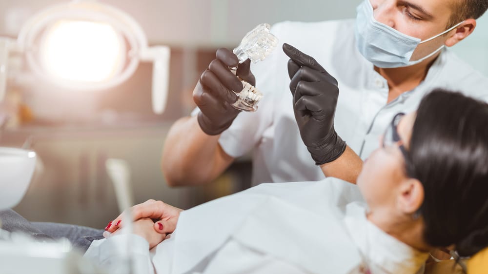 A dentist performs an occlusal analysis during a thorough examination of a patient's teeth for optimal care