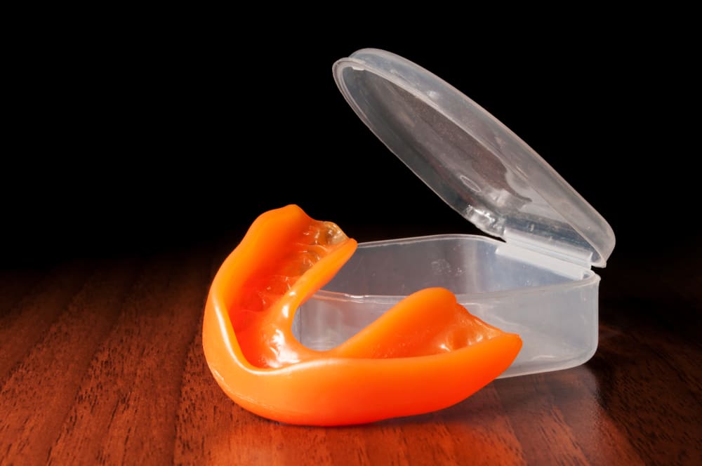 A sports mouthguard with a protective case, designed to prevent dental injuries during physical activities