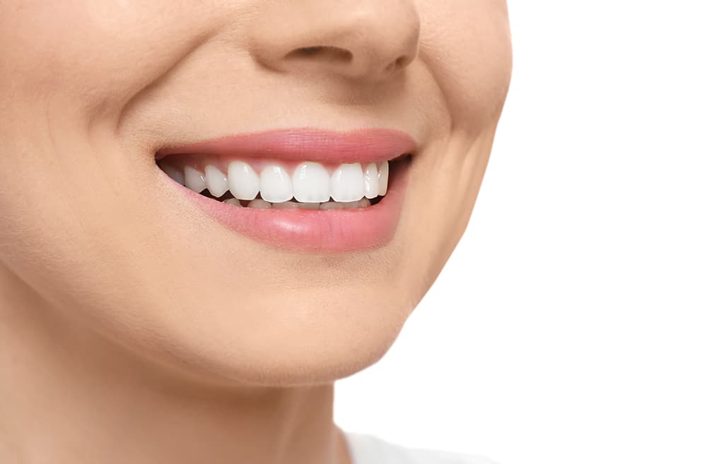 A woman with bright white teeth smiling confidently, showcasing the results of cosmetic dentistry service